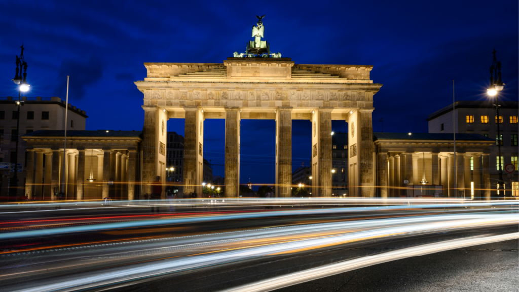 Berlin's Brandenburg Gate at twilight with streaks of traffic lights, representing Germany's robust economy and strategic position for UK-based companies' expansion in Europe