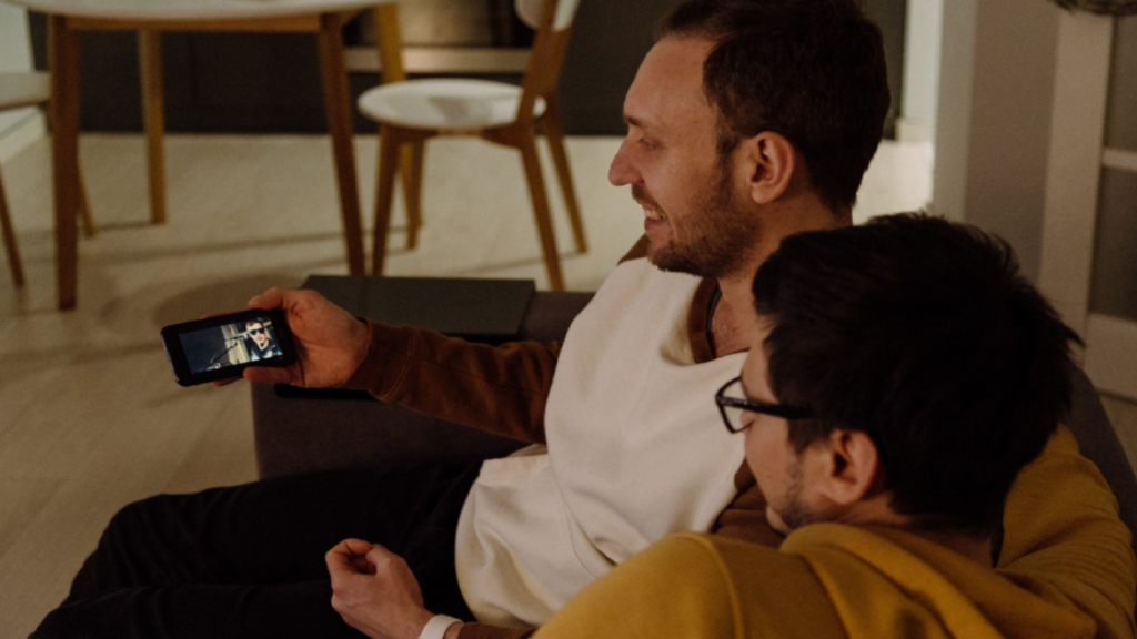Two people enjoying Netflix on a smartphone, showcasing portable streaming worldwide