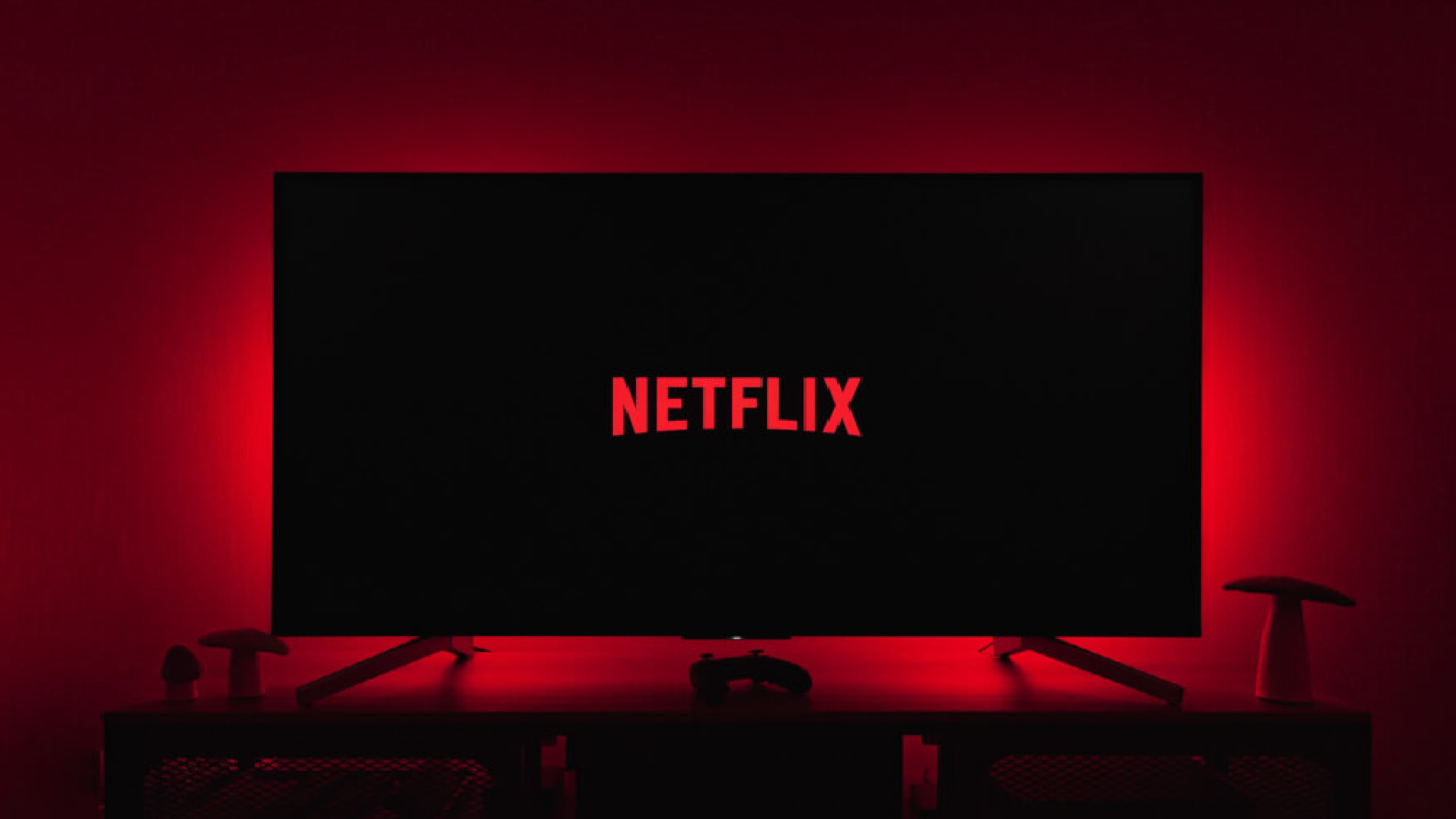 Netflix logo illuminating a room in red, symbolizing its global streaming presence